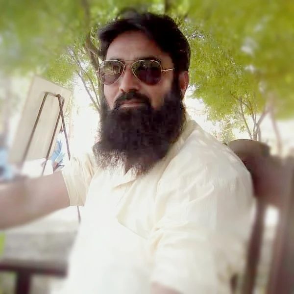 A man wearing gold aviator sunglasses outdoors